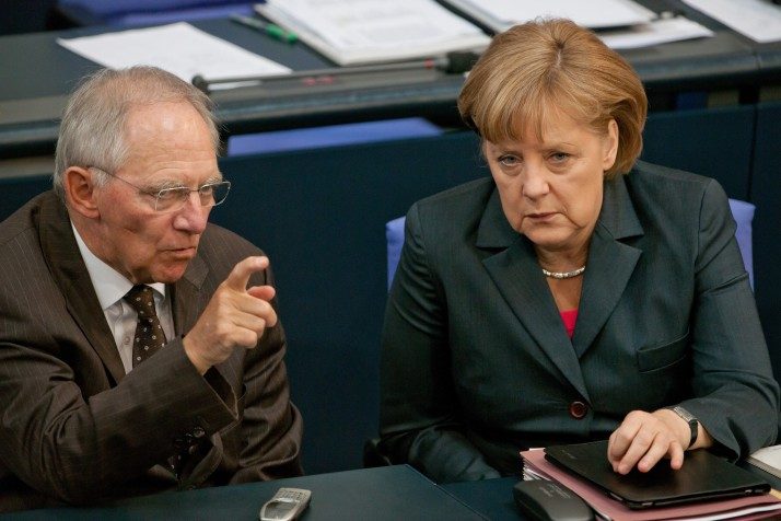 epa03264122 German Chancellor Angela Merkel (R) talks to German Finance Minister Wolfgang Schaeuble (L), after her state of the nation address before the upcoming G20 summit conference in Mexico, at the Bundestag in Berlin, Germany, 14 June 2012. Merkel defended her much criticised course in the Euro crisis and warned against excess of Germany's demands with new financial ties. EPA/TIM BRAKEMEIER